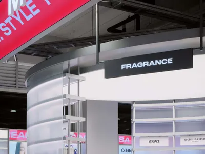 Modern retail fragrance counter featuring a tall curved frosted acrylic display tower with integrated lighting and white modular shelving units.