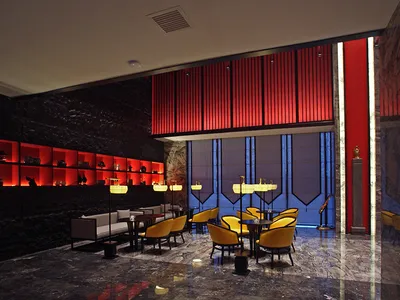 Luxury hotel lobby lounge featuring black marble walls with glowing red backlit shelves, bold red vertical slat feature wall, polished marble floor, and golden yellow velvet armchairs arranged in intimate seating groups.