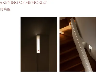 Modern minimalist interior featuring a tall vertical wall light in a dark hallway next to a wooden staircase with white handrail and warm sunlight.