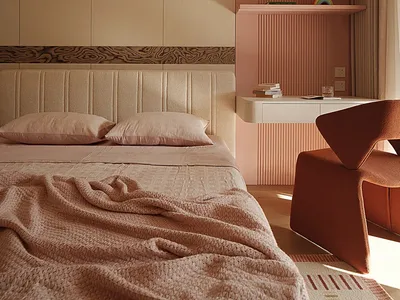 Modern bedroom featuring a beige upholstered bed with pink bedding, a terracotta sculptural armchair, and a two-tone wall with beige cabinetry and a pink fluted accent wall with floating shelves.