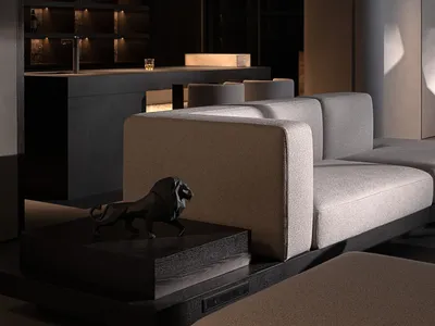 Modern minimalist living room featuring a dark concrete home bar with backlit bottle display, a light gray modular sofa, and a black geometric lion sculpture on a dark wood plinth.