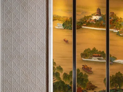 Modern Chinese-style living room featuring a large golden traditional landscape painting, white textured geometric wall, dark marble floor, and a cream sculptural swivel chair.