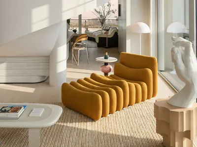 Modern minimalist living room featuring a dramatic white spiral staircase, mustard yellow curved modular sofa, light wood flooring, and large windows with harbor view.