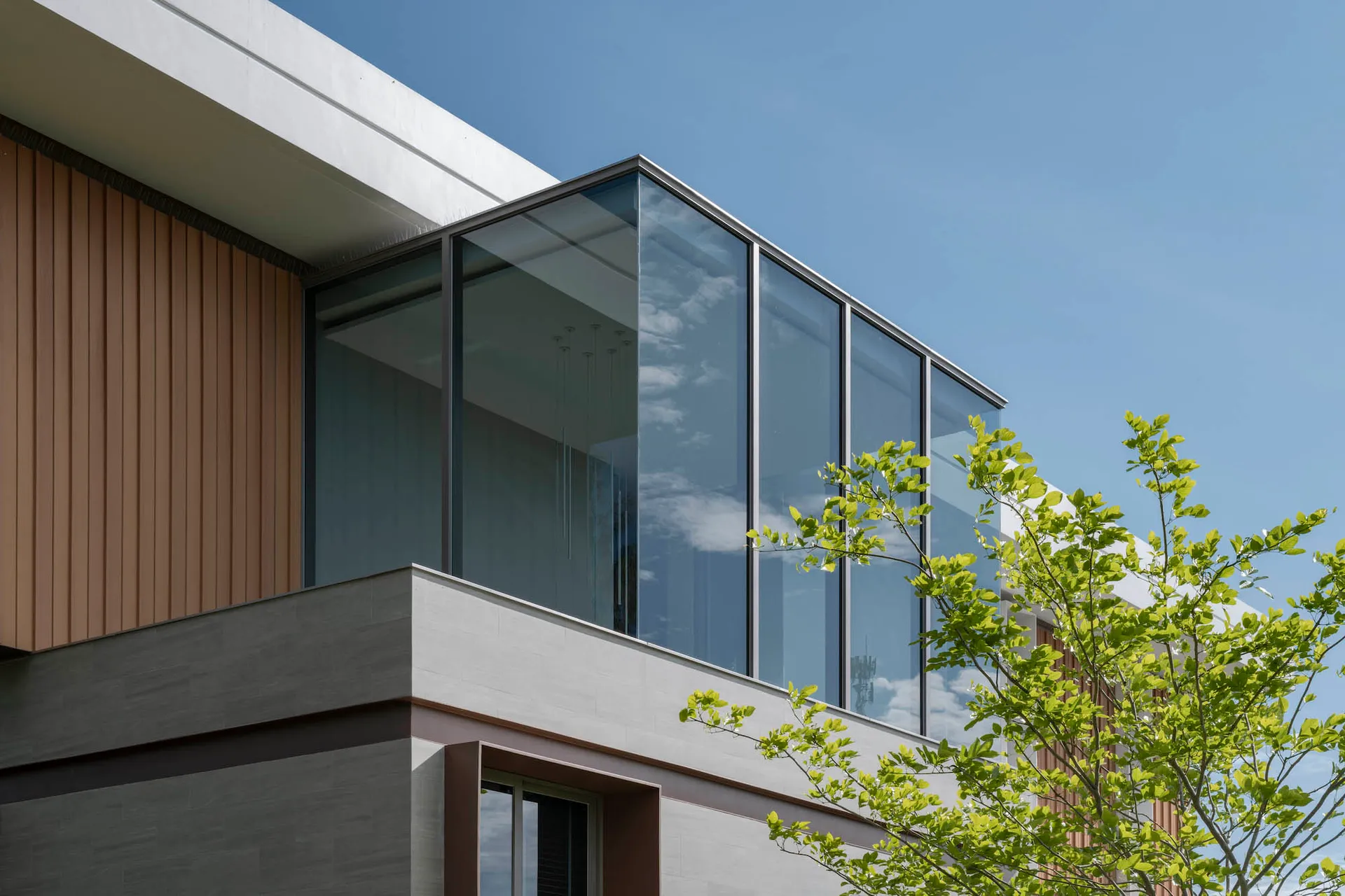 Modern building exterior featuring glass and concrete materials.