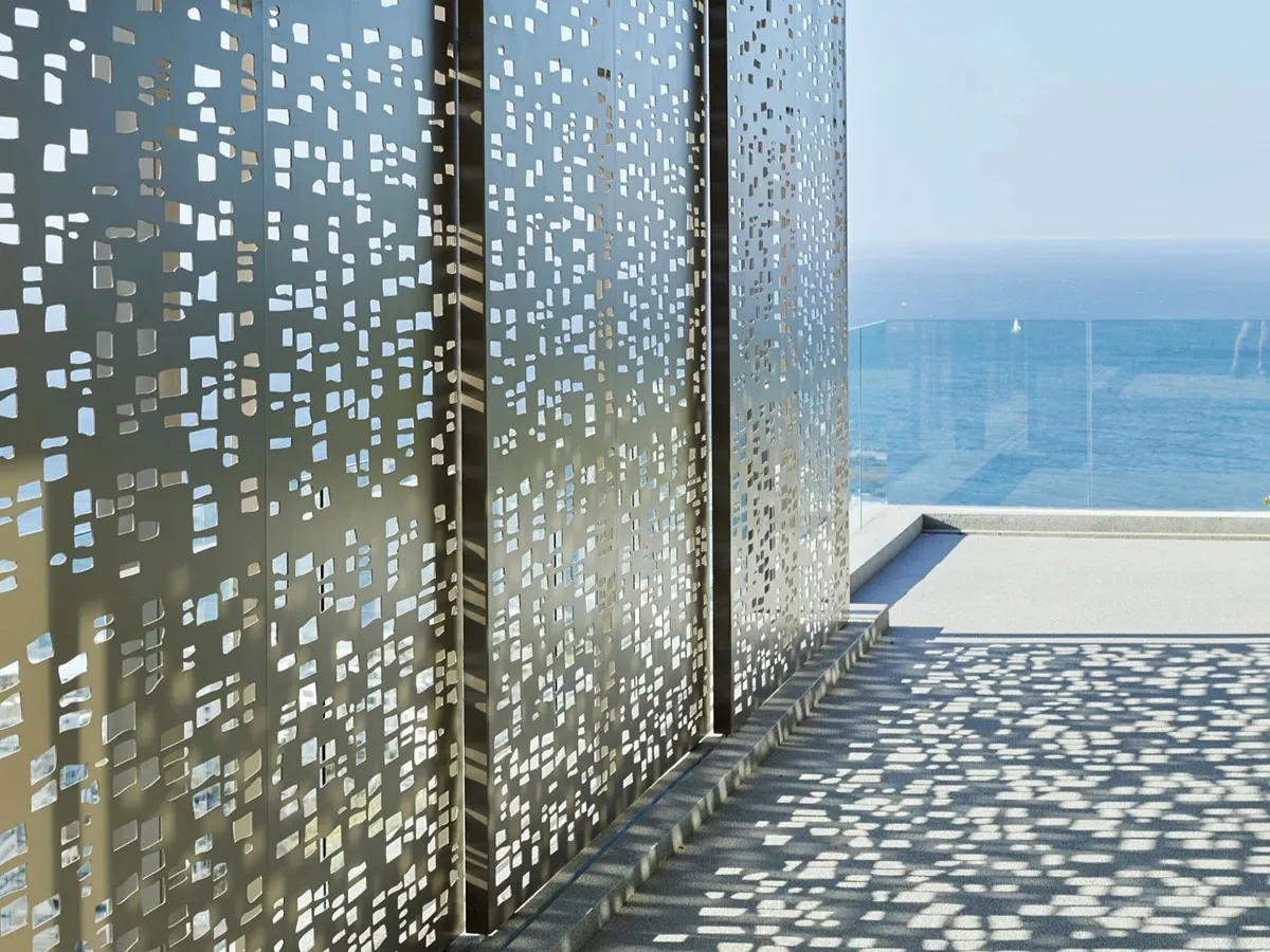 Modern outdoor space featuring a wall of metal perforated panels