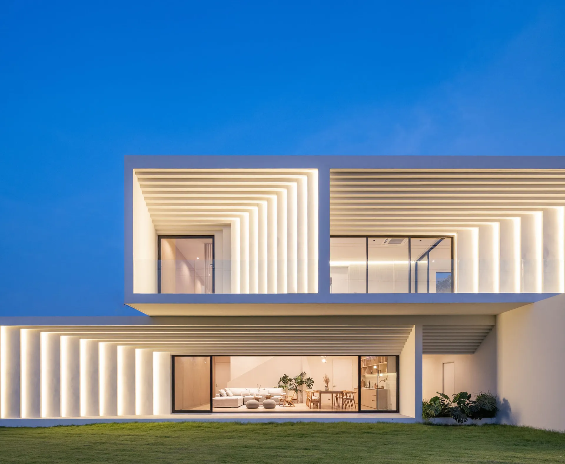 Modern residential home exterior with concrete and glass panels