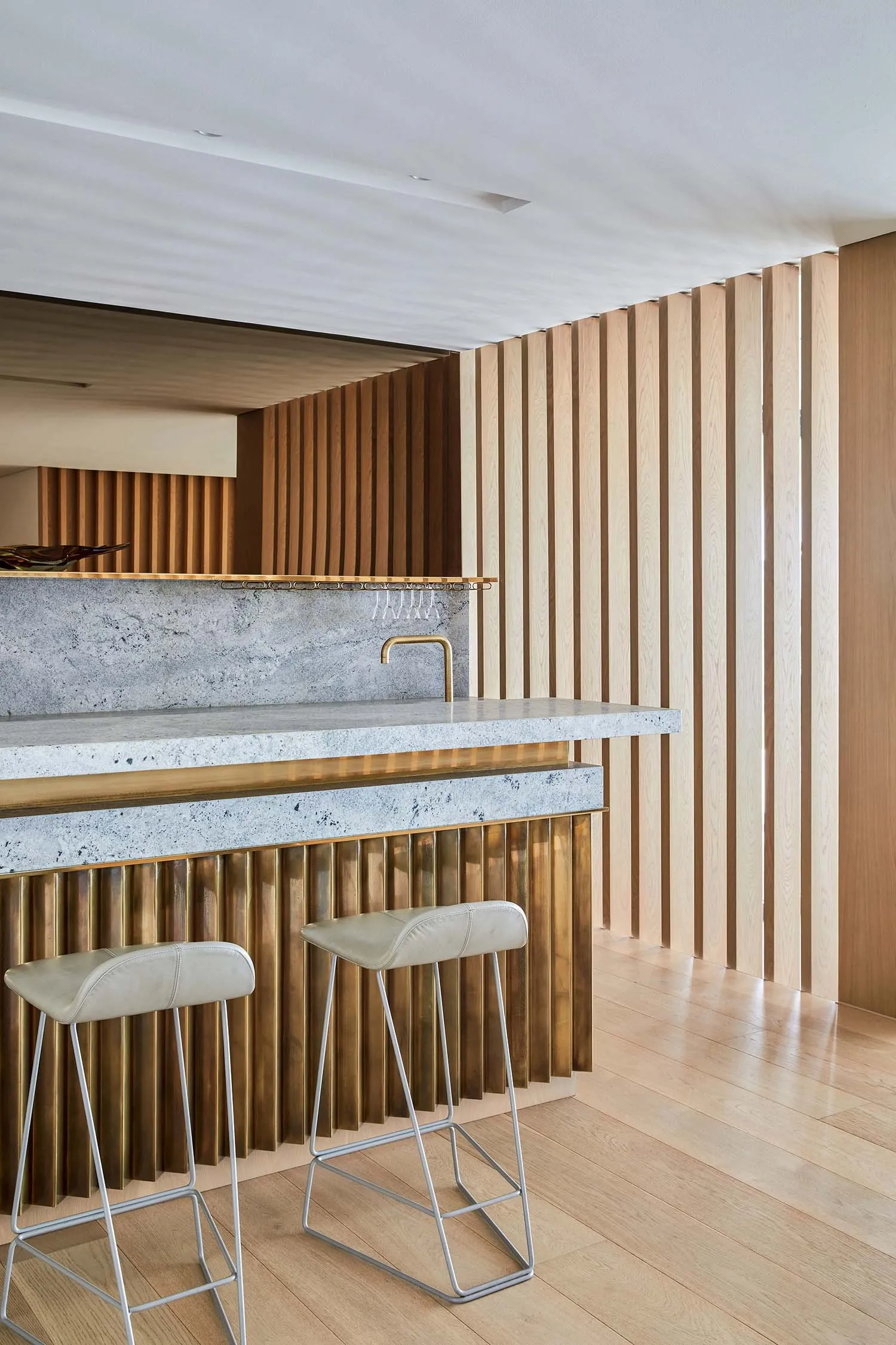 A modern residential kitchen featuring wood and brass accents.