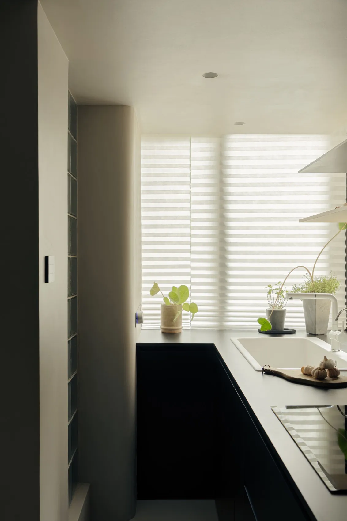 An elegant, minimalist kitchen with a granite countertop.