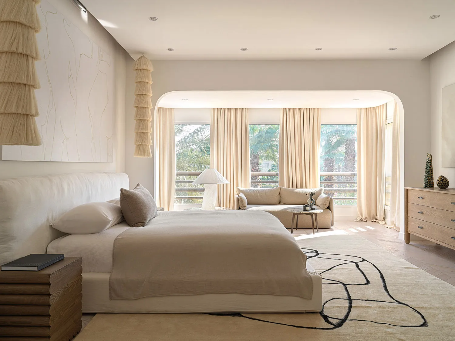 A modern bedroom featuring a sofa and fabric elements.
