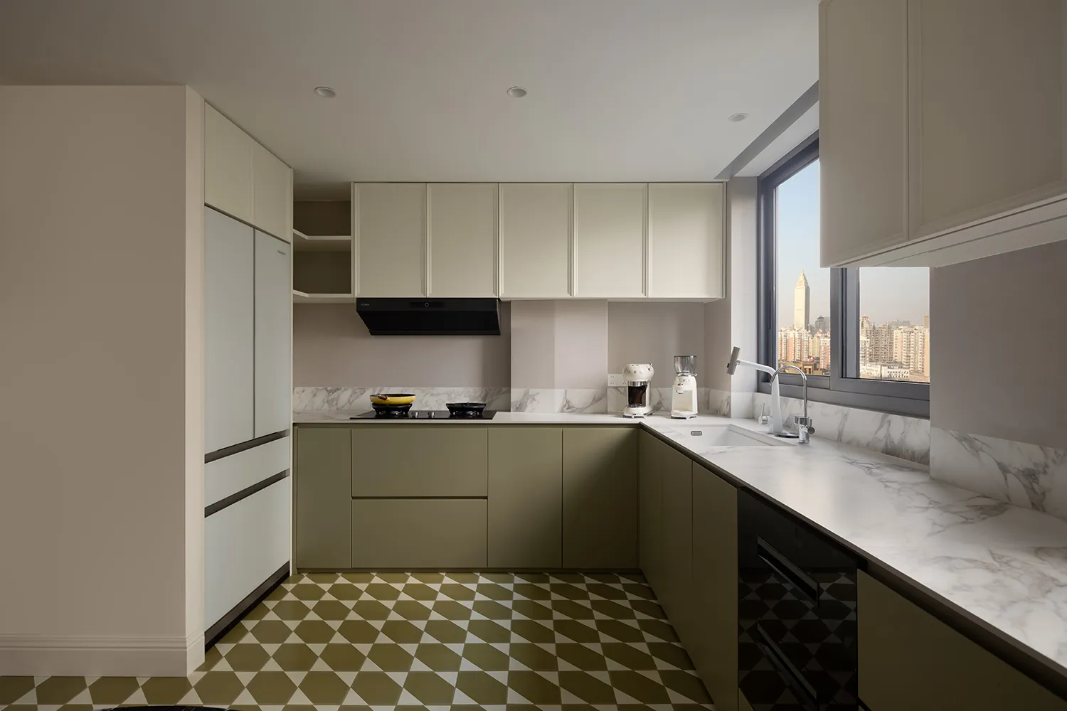 Modern kitchen with marble countertops, stainless steel appliances, and a view of the cityscape through the window.