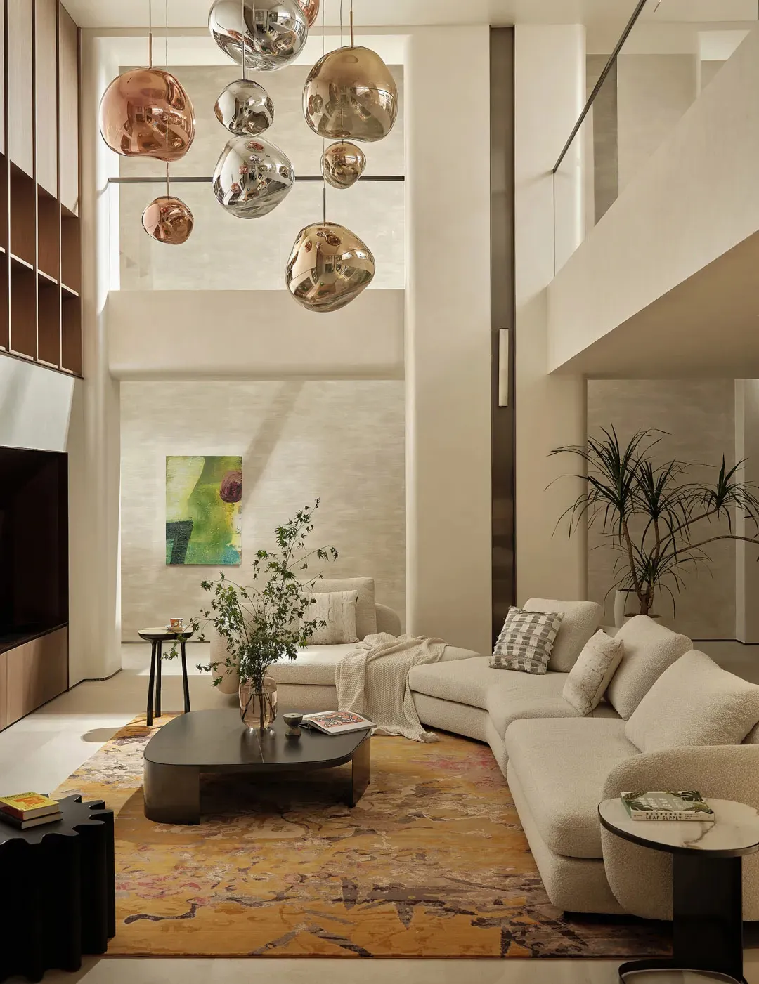 Modern living room with fabric furniture, abstract wall art, and statement pendant lights.