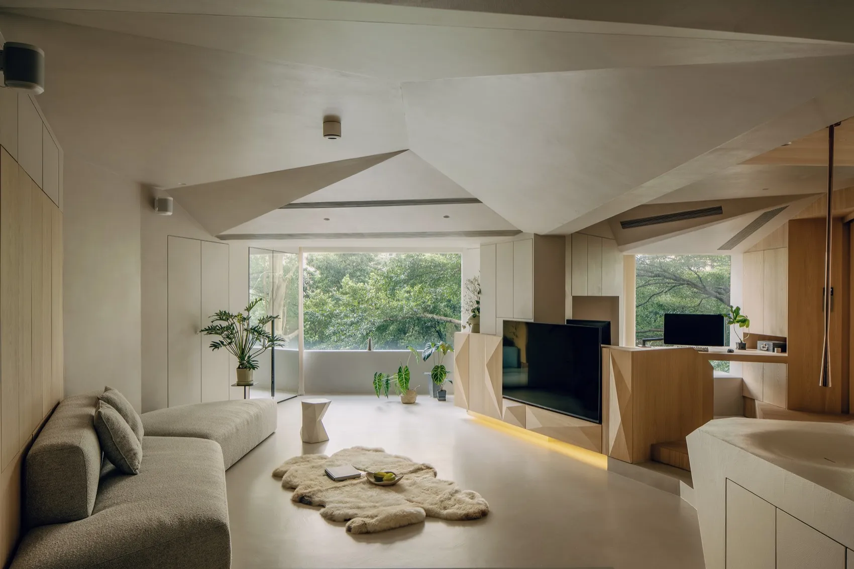A modern living room with natural wooden furniture and light-colored flooring.