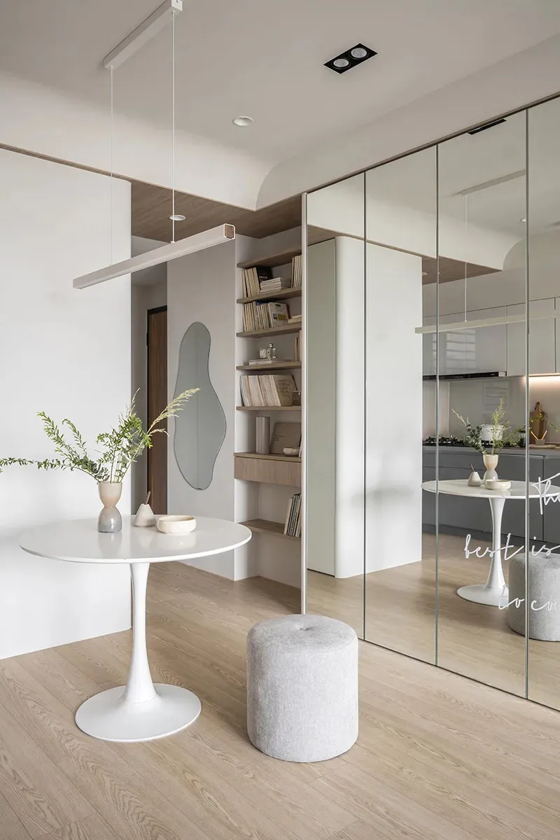 Modern minimalist kitchen featuring white countertops and gray backsplash