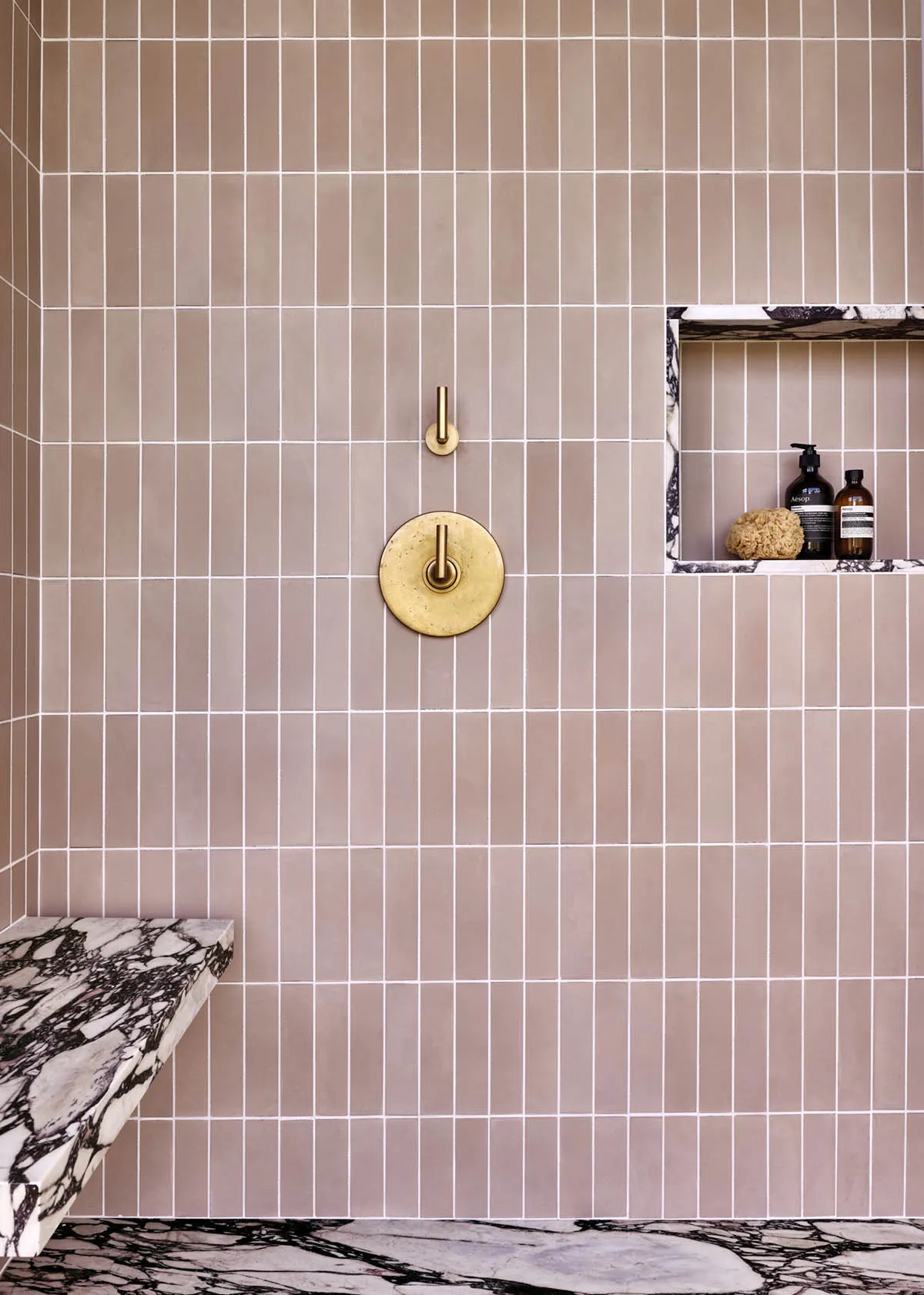 A modern bathroom featuring tiles on the walls and floor.