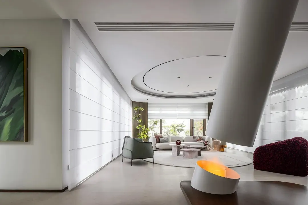 Modern, white, minimalist living room with circular ceiling feature and large windows