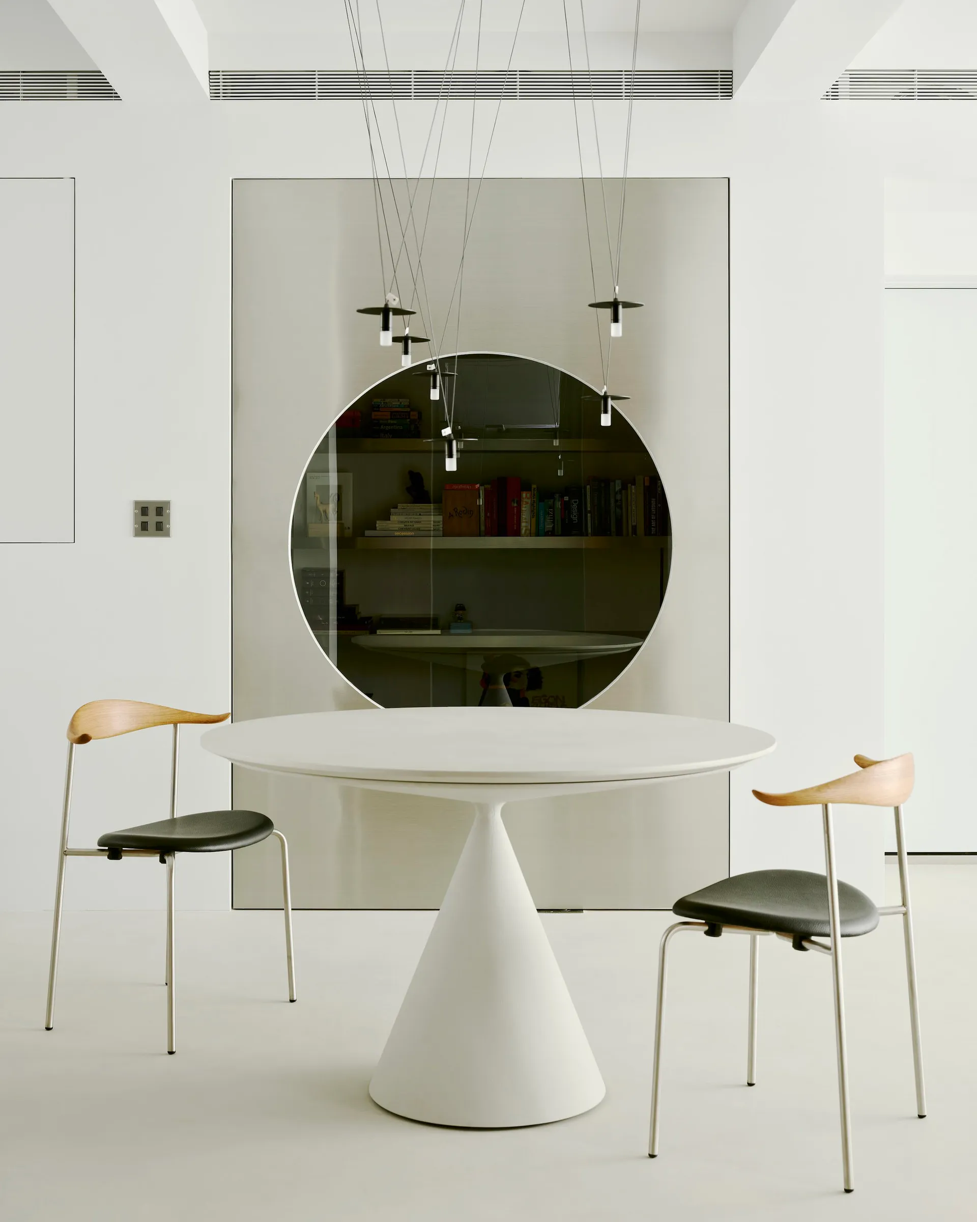 Minimalist design featuring concrete and glass materials in interior space.