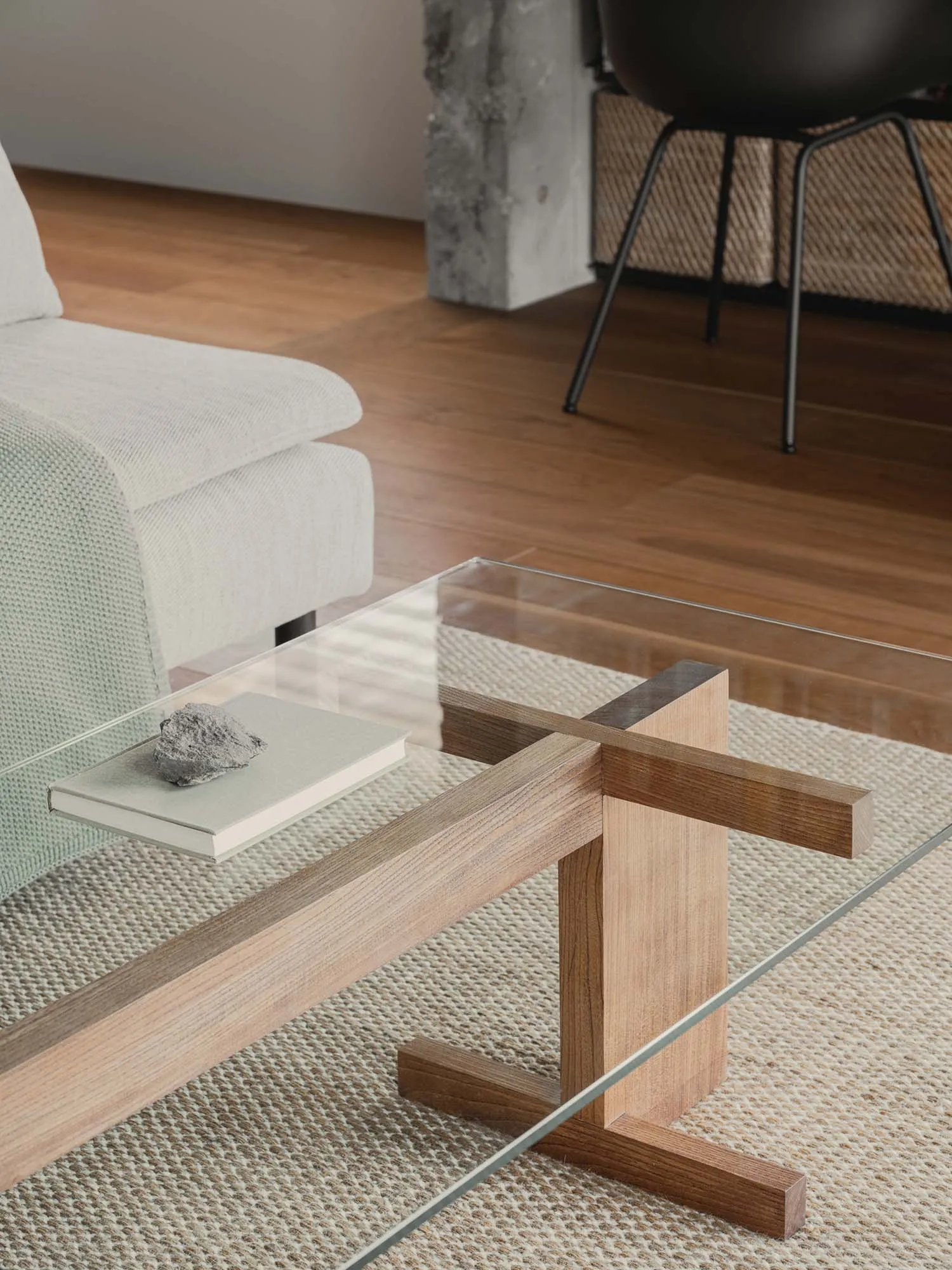 A modern coffee table featuring glass top and wooden legs with a minimalist design.