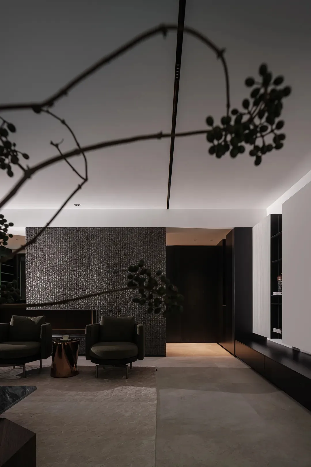 A modern living room featuring dark metallic texture walls and minimalist black seating.