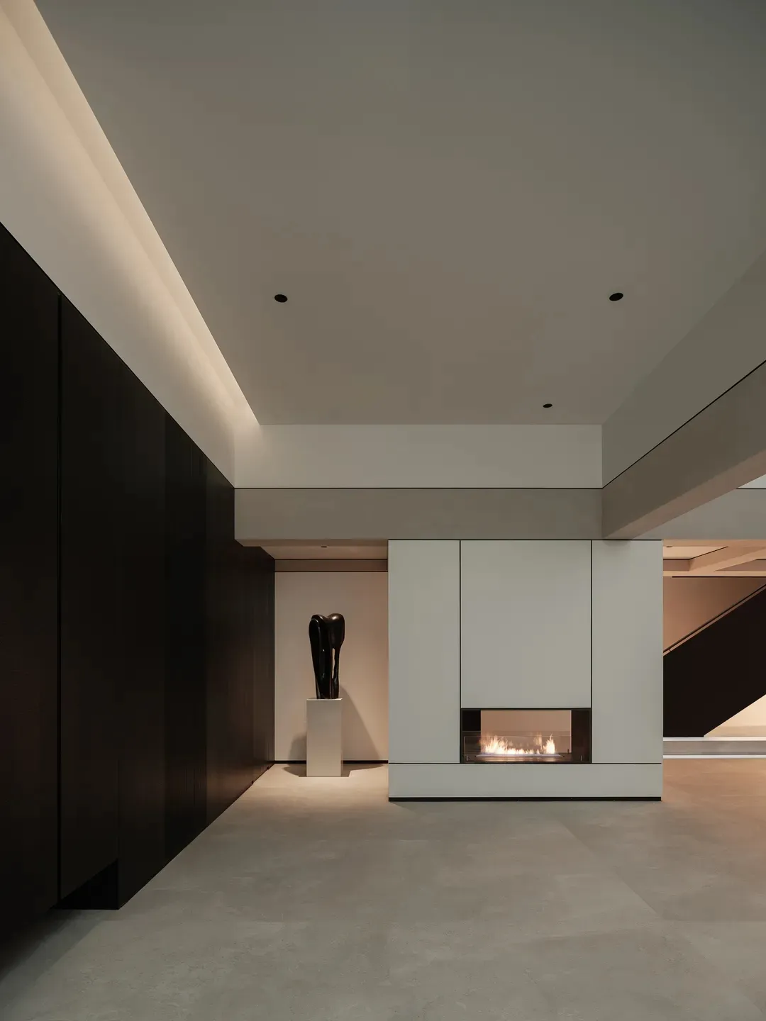 Modern minimalist interior with concrete walls and glass fireplace