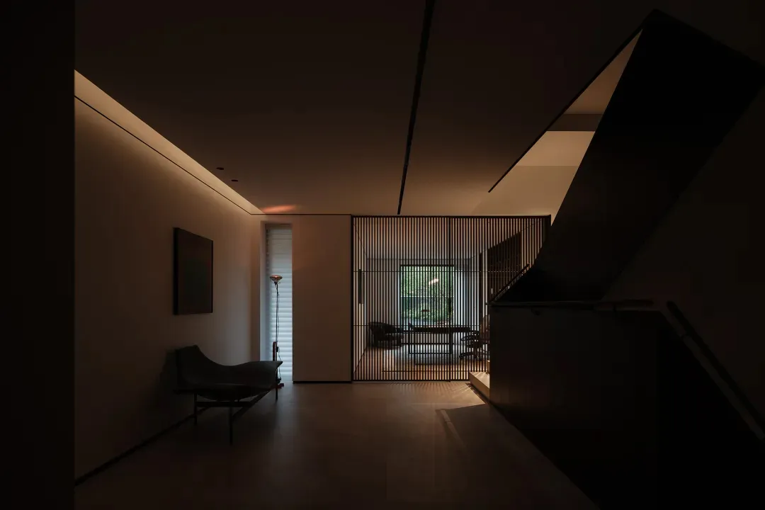 Minimalistic modern living room with wooden flooring and furniture.