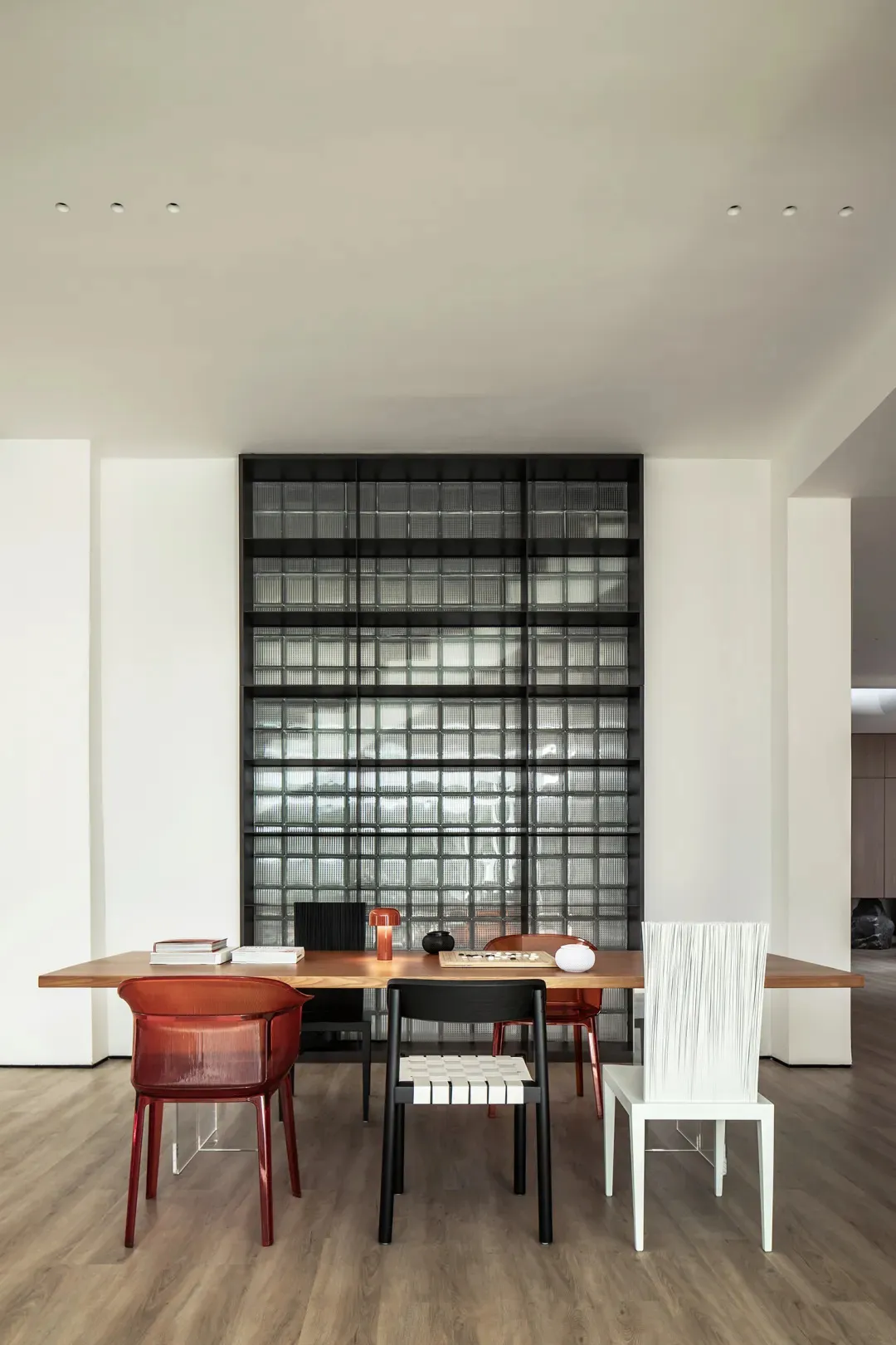 A modern office space featuring a wooden desk with various chairs.