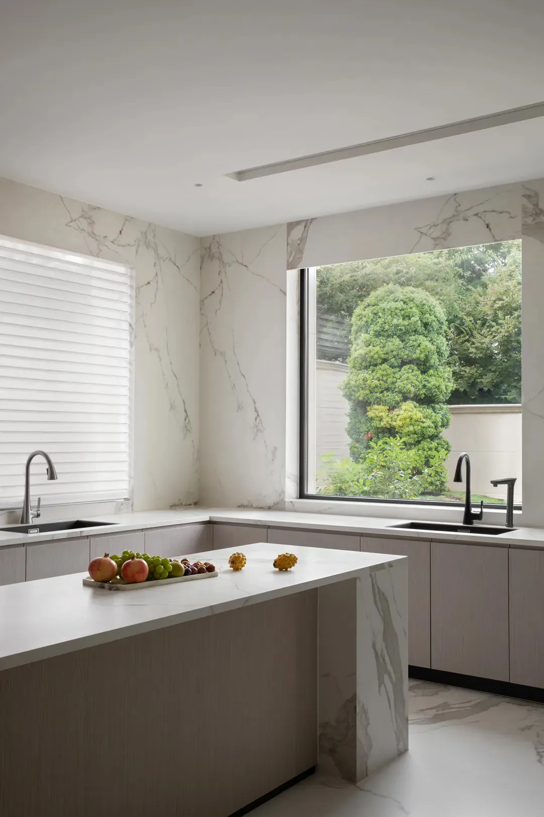 Modern, minimalist kitchen featuring marble countertops and backsplash, with a large window offering a view of lush greenery.