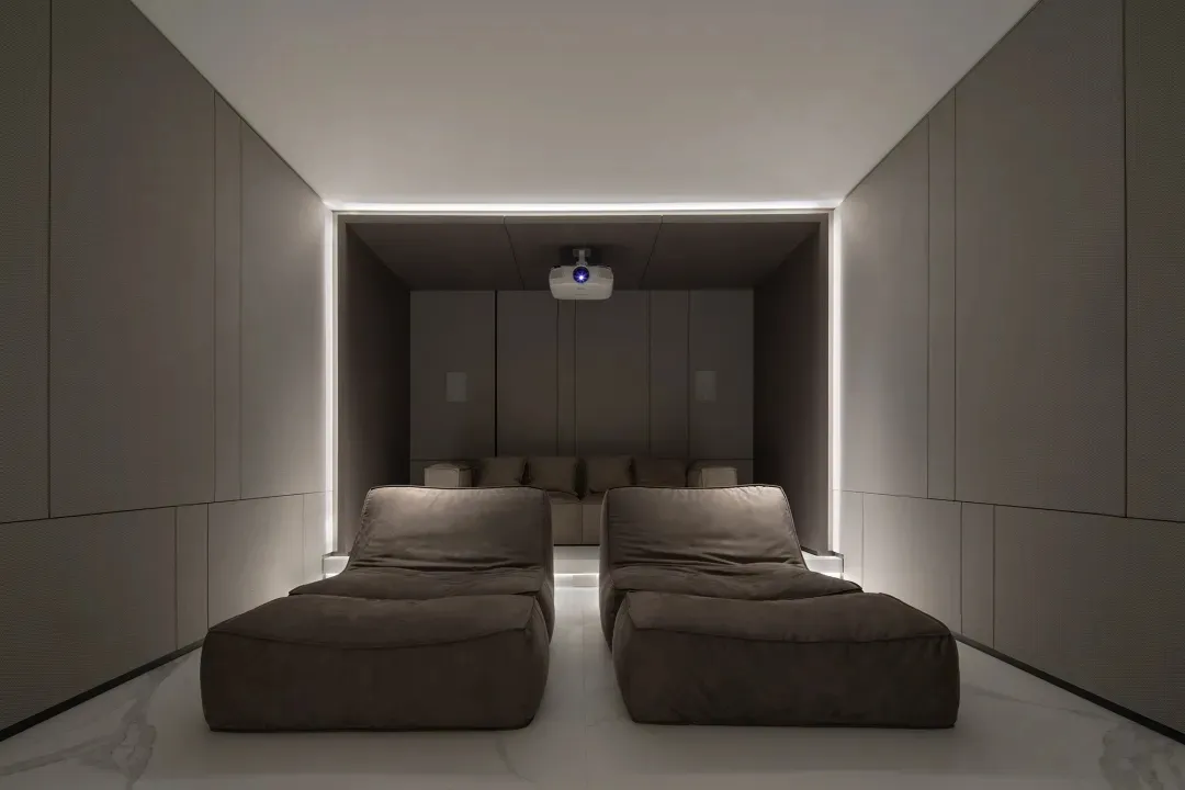 A modern home theater with fabric seats, featuring a minimalist design and ambient lighting.