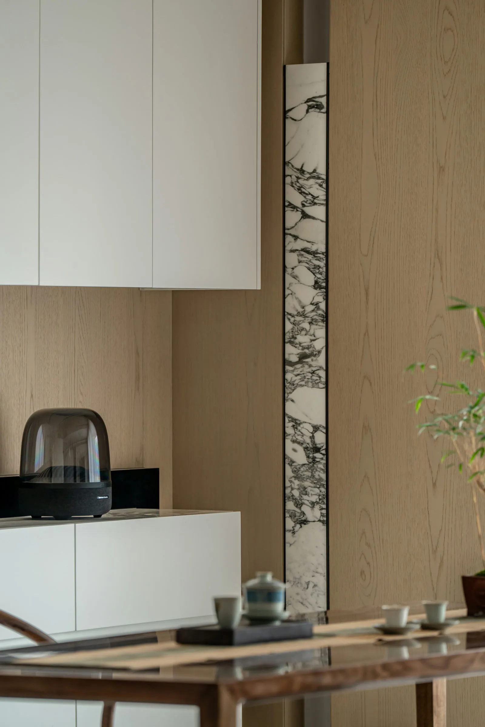 Contemporary space featuring wooden furniture and marble accents.