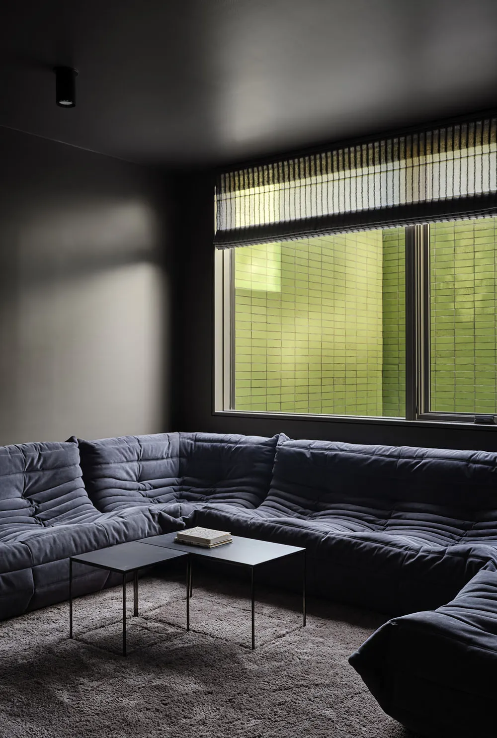 A modern living room featuring a fabric sectional sofa.