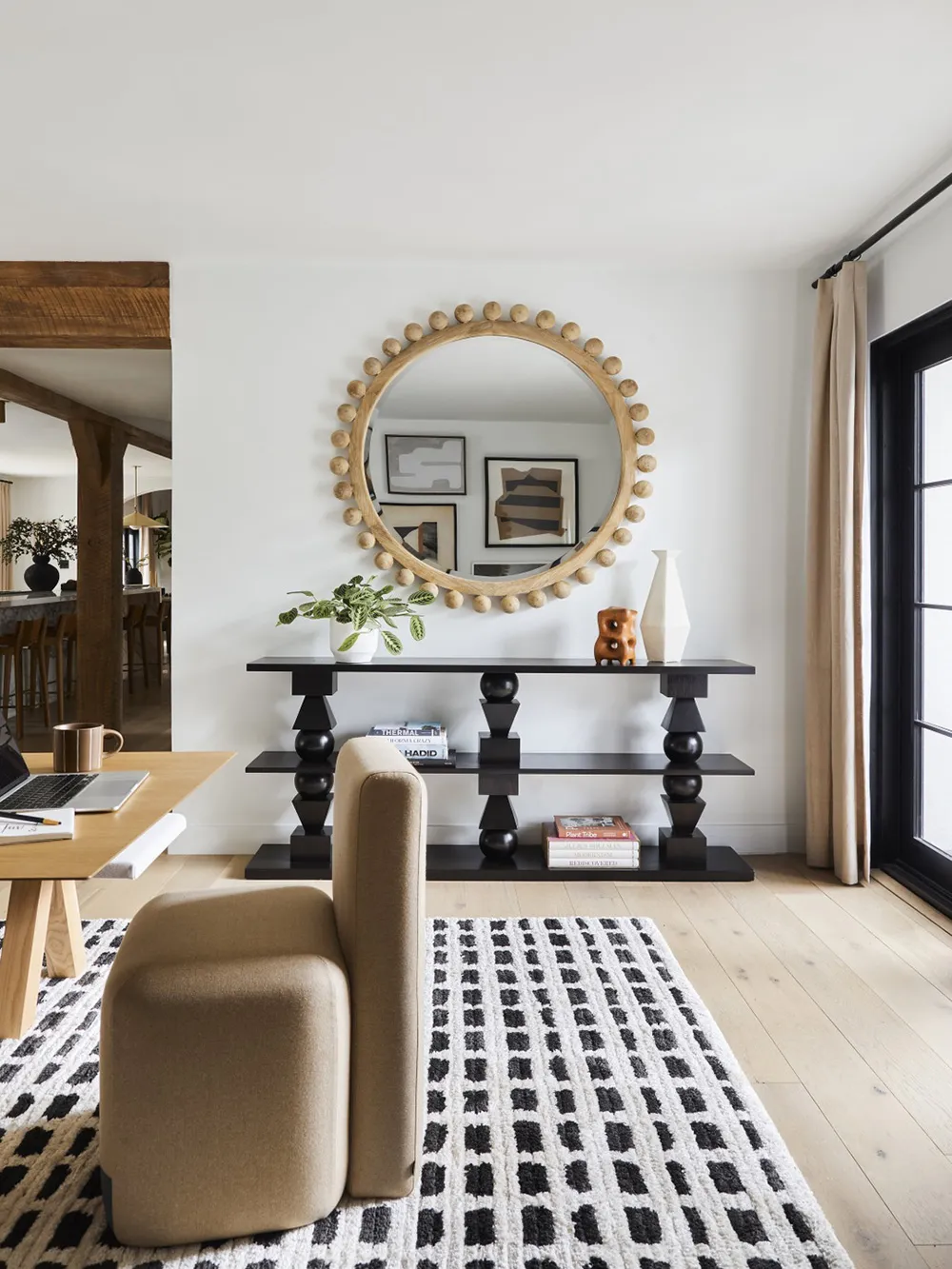 A modern living room featuring wooden furniture, fabric seating, and metal decor.