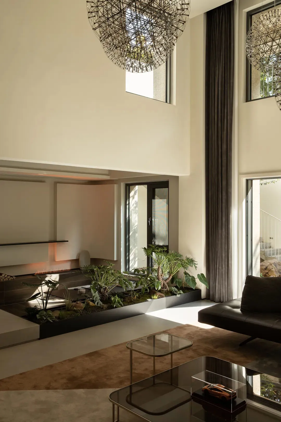 Modern living room featuring concrete, glass, and metal materials.
