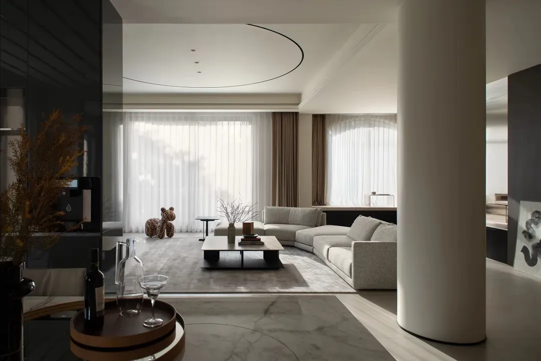 Modern living room with minimalist design, featuring white concrete furniture and a neutral color palette