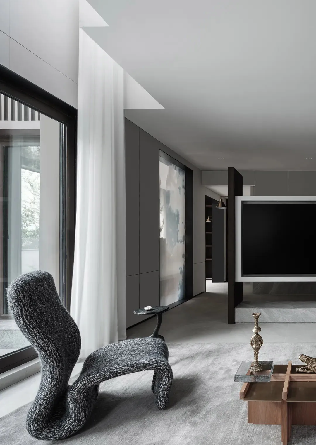 A modern living room with concrete walls and a minimalist design.