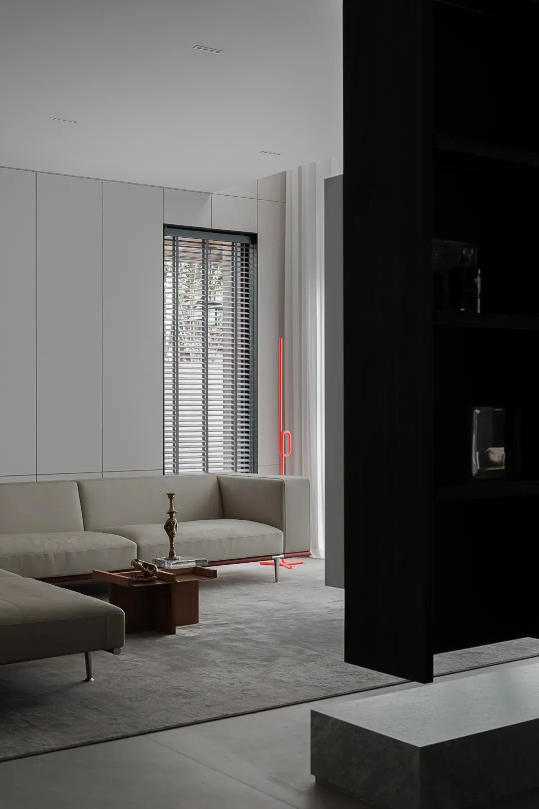 Modern living room with minimalist design, featuring shades of grey and concrete materials, showcasing sleek, contemporary fu