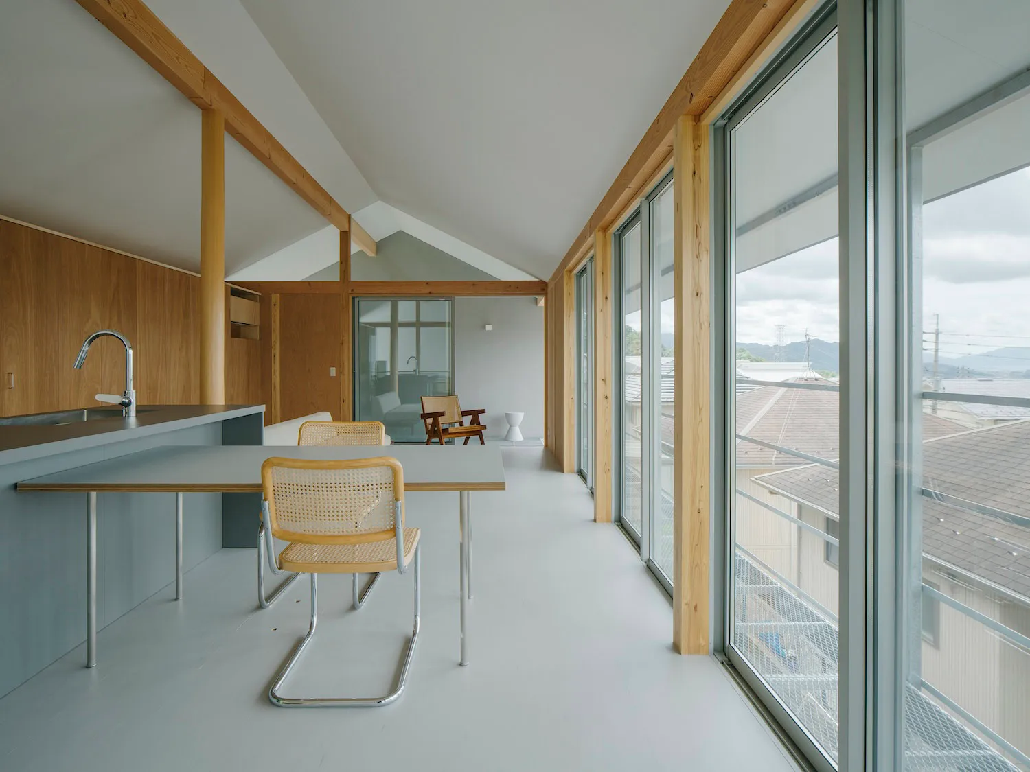 Modern, minimalist kitchen featuring glass and steel materials.