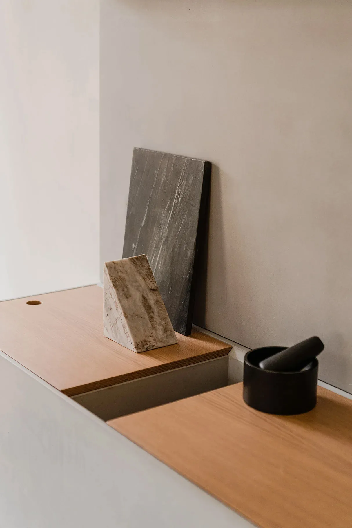 A minimalist office space featuring a combination of wood and concrete materials.