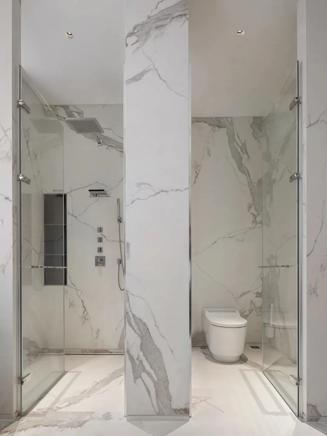 A modern bathroom featuring marble walls and floor, with a shower and toilet.