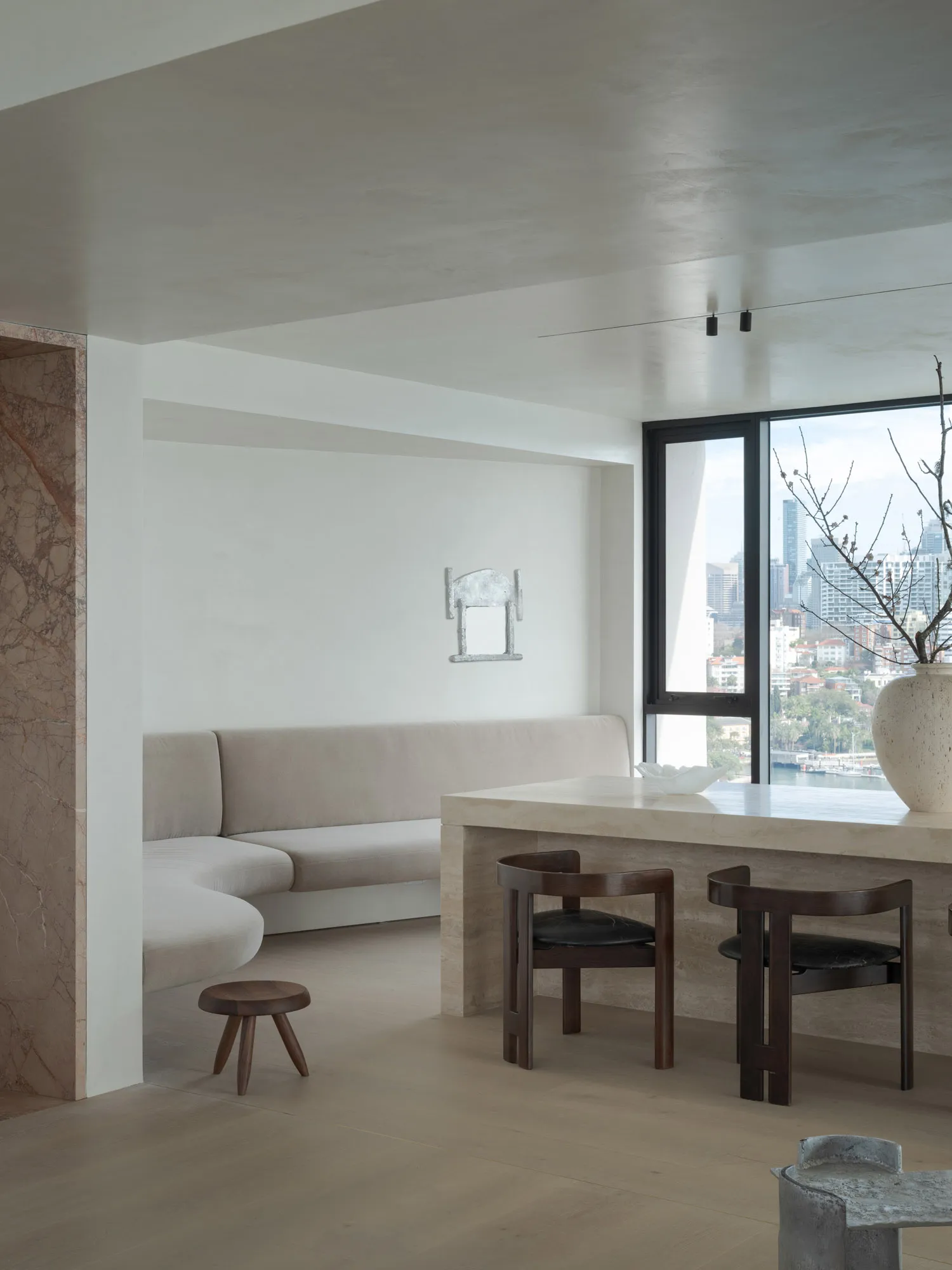 Contemporary interior design featuring a living room with a stone accent wall and floor.