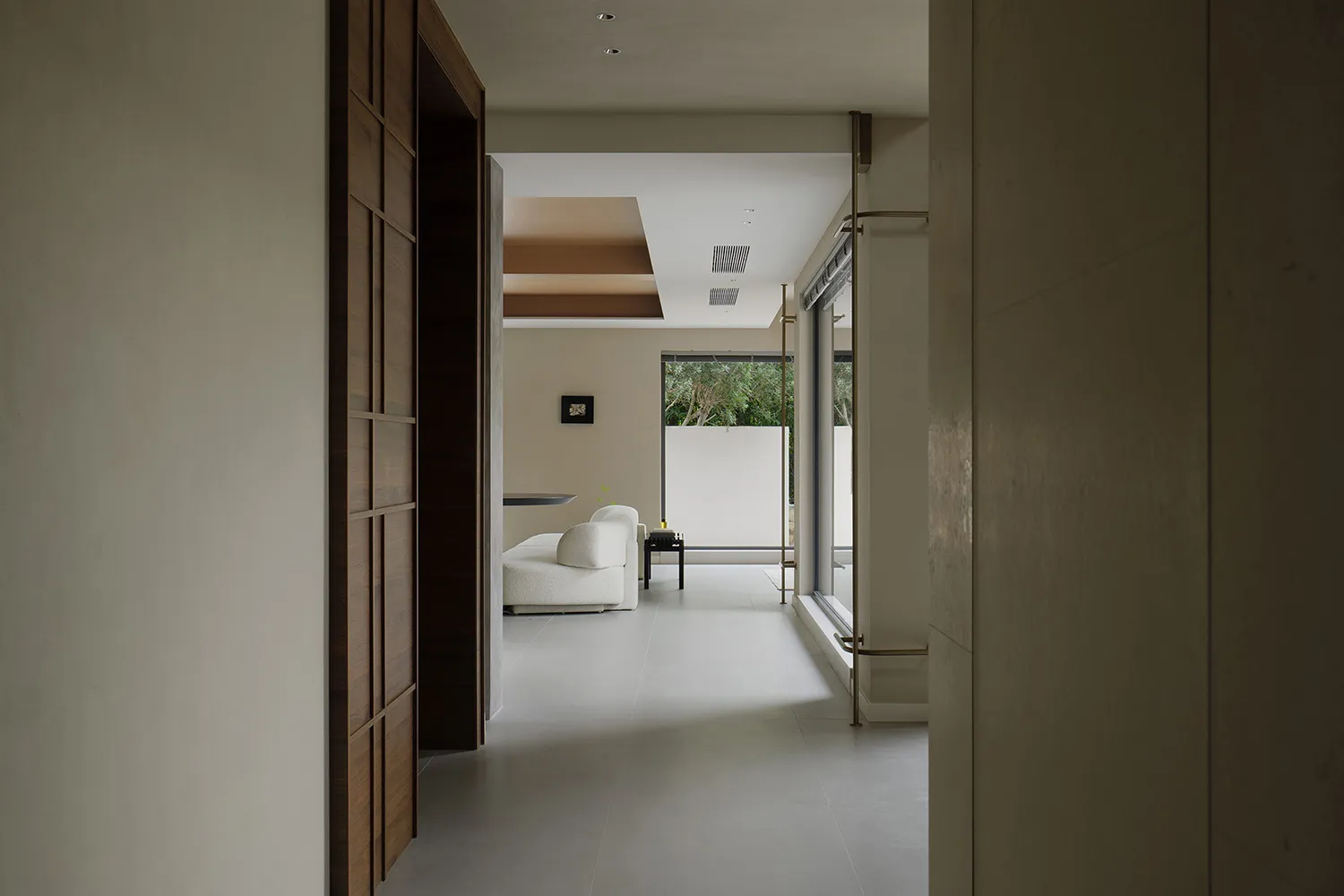 A minimalist living room featuring concrete walls and floor.