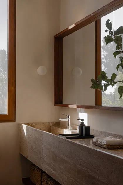 Minimalist bathroom with a marble counter, sink, and faucet.
