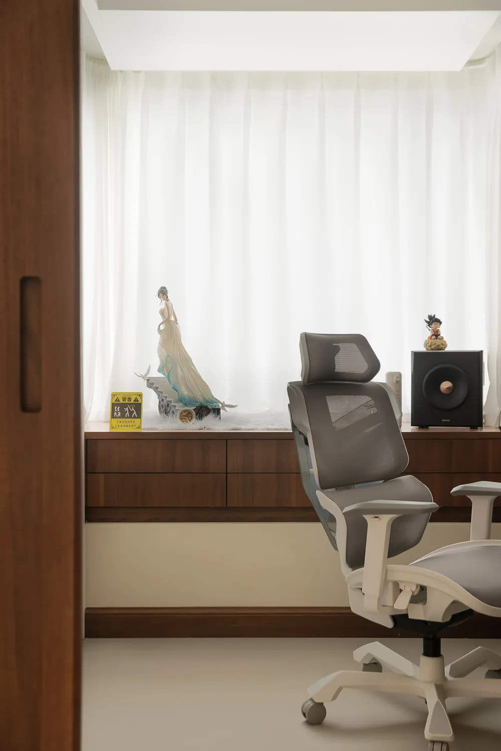 A minimalist home office with modern furniture, wooden accents, and glass surfaces.