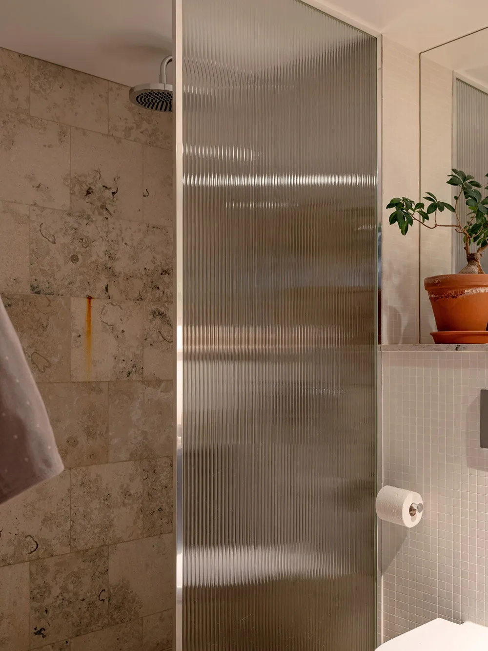 A minimalist bathroom featuring a glass shower enclosure.