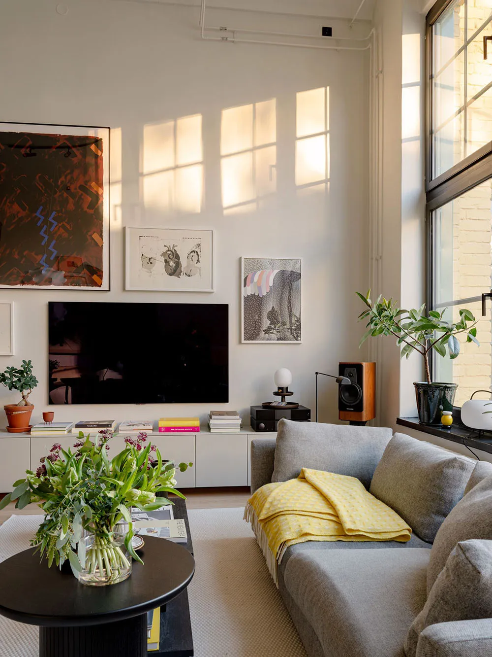A modern living room with mixed materials including white walls, colorful furniture, and a rug.