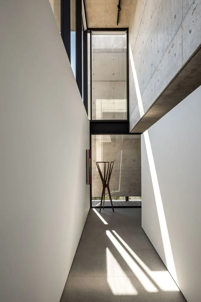 A modern minimalist interior with concrete walls and floor.