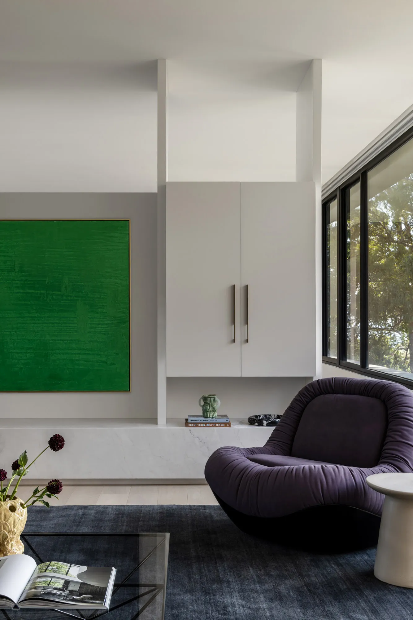 Modern minimalist living room featuring marble, glass, and metal accents.