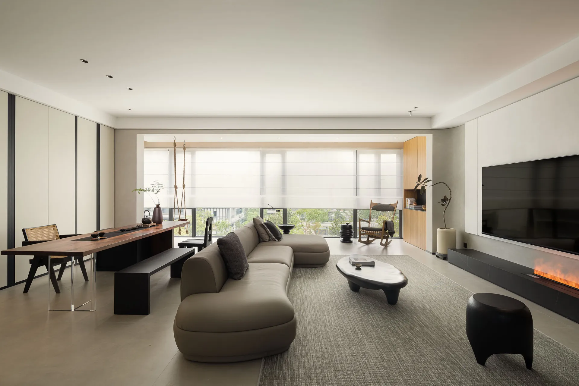 Modern minimalist living room featuring concrete tiles and a sleek, open layout.