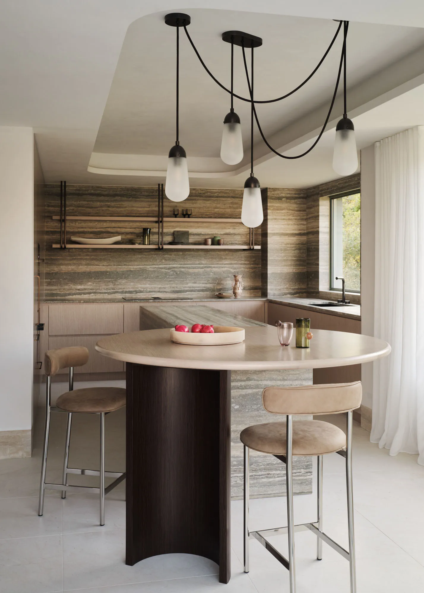 Modern minimalist kitchen with marble countertops and stainless steel appliances.