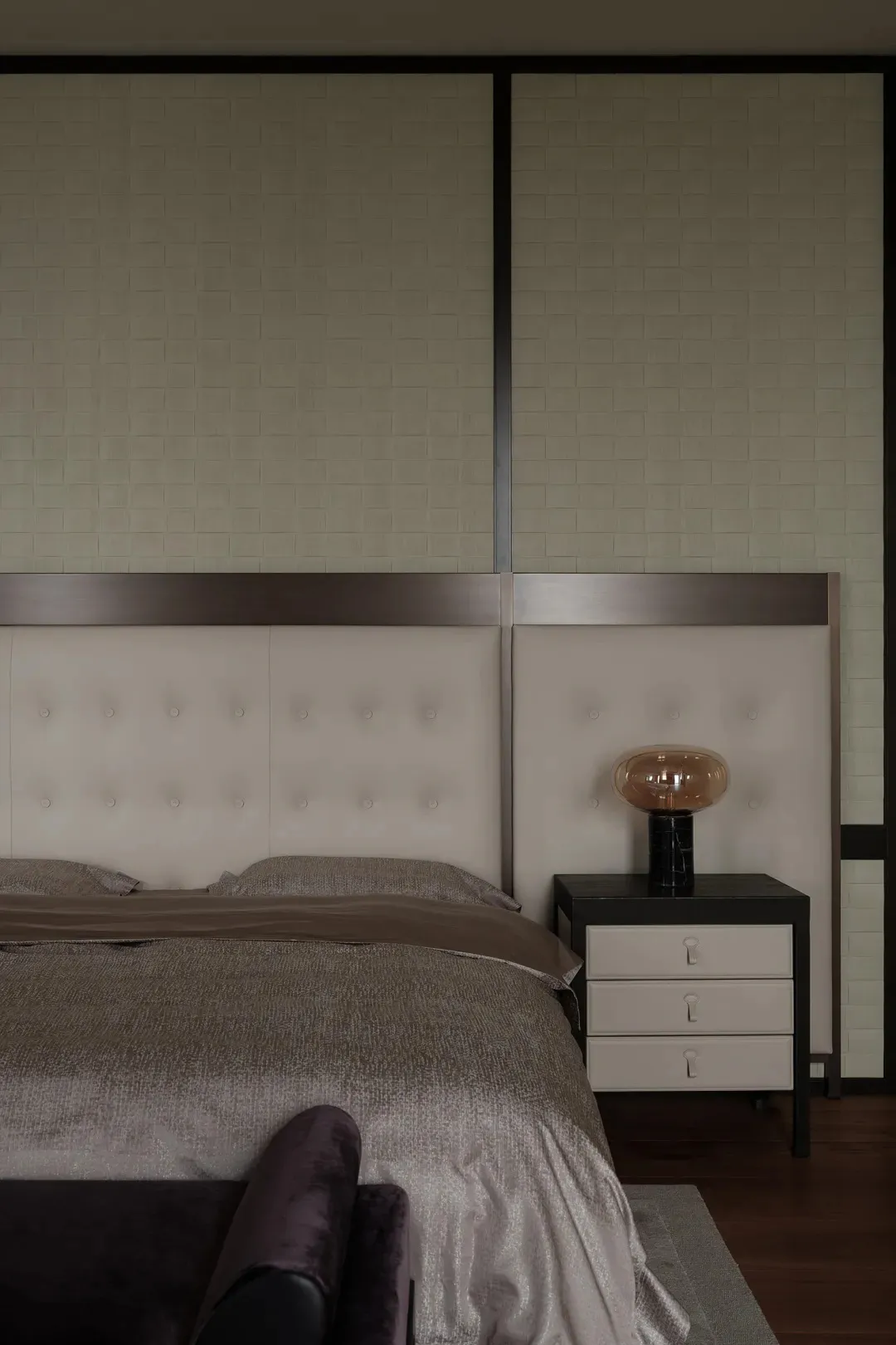 A modern bedroom featuring a white upholstered headboard made of contemporary furniture materials.