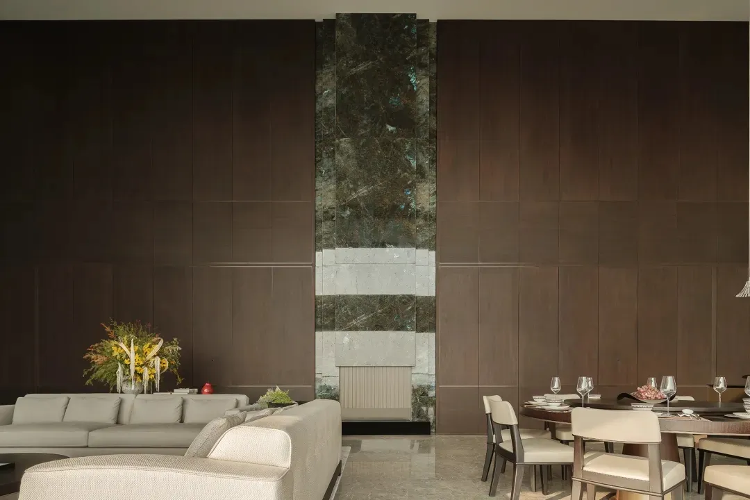 Contemporary living and dining areas with wooden furnishings and marble accents