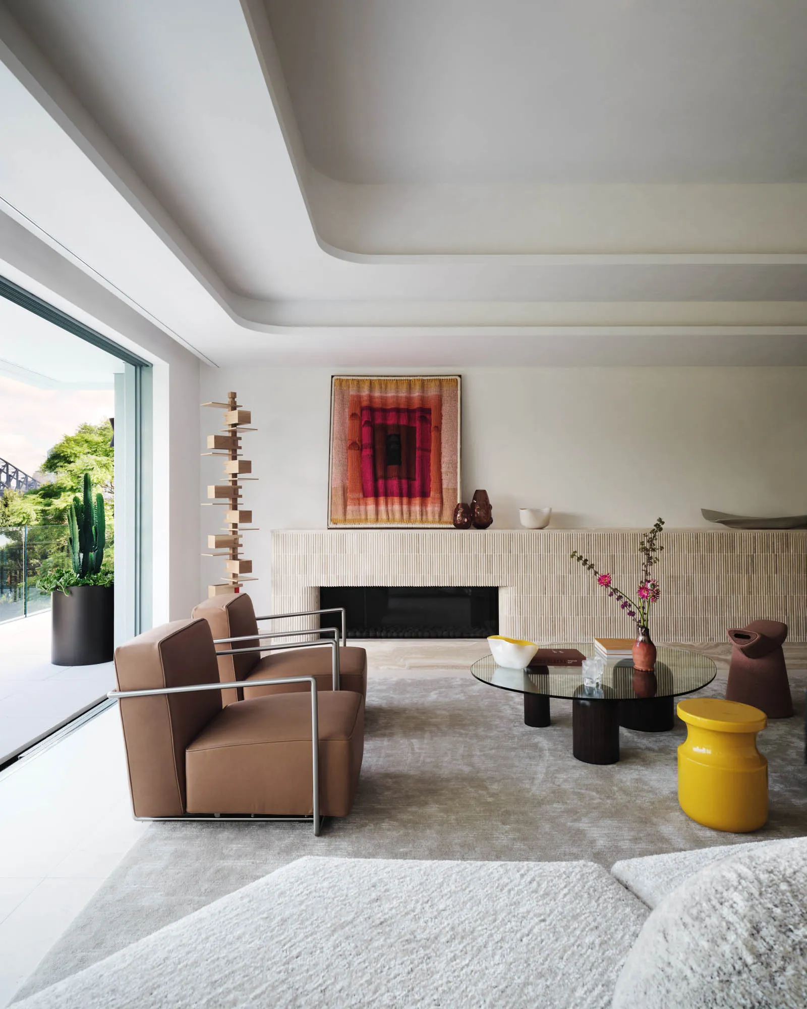A modern living room featuring neutral-toned furniture and minimalistic decor.